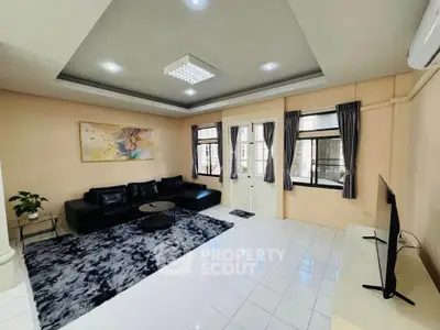 Spacious living room with modern decor and large windows