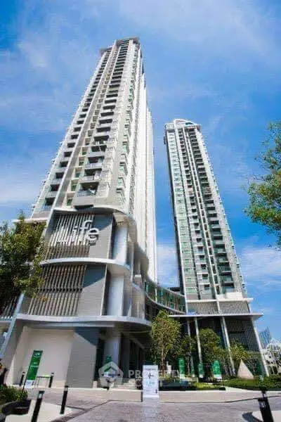 Stunning modern high-rise residential towers with sleek design and lush surroundings.