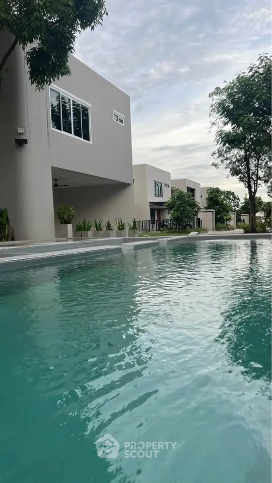 Modern residential complex with pool and contemporary architecture.