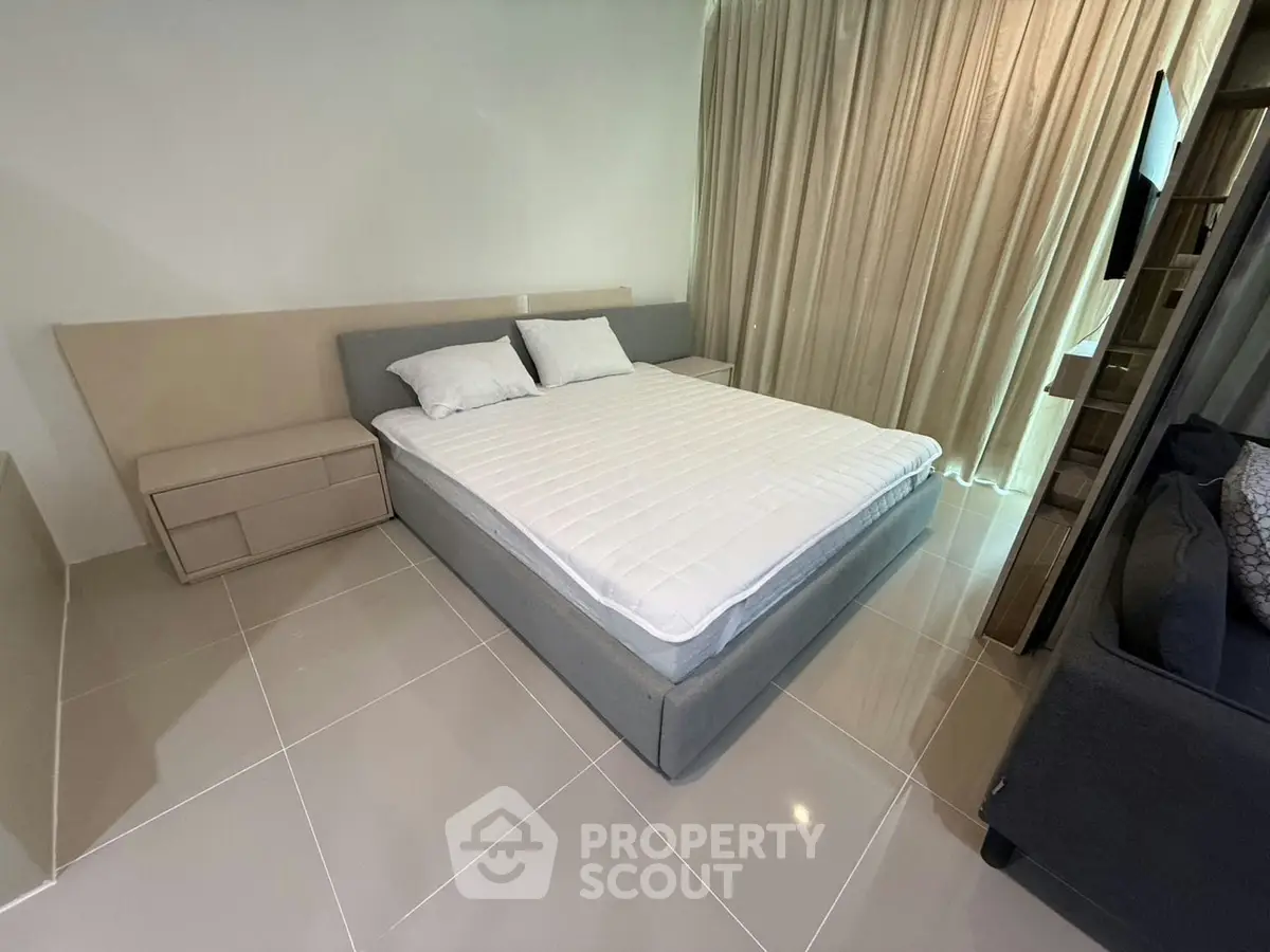 Modern bedroom with sleek design and cozy ambiance, featuring a comfortable bed and elegant furnishings.