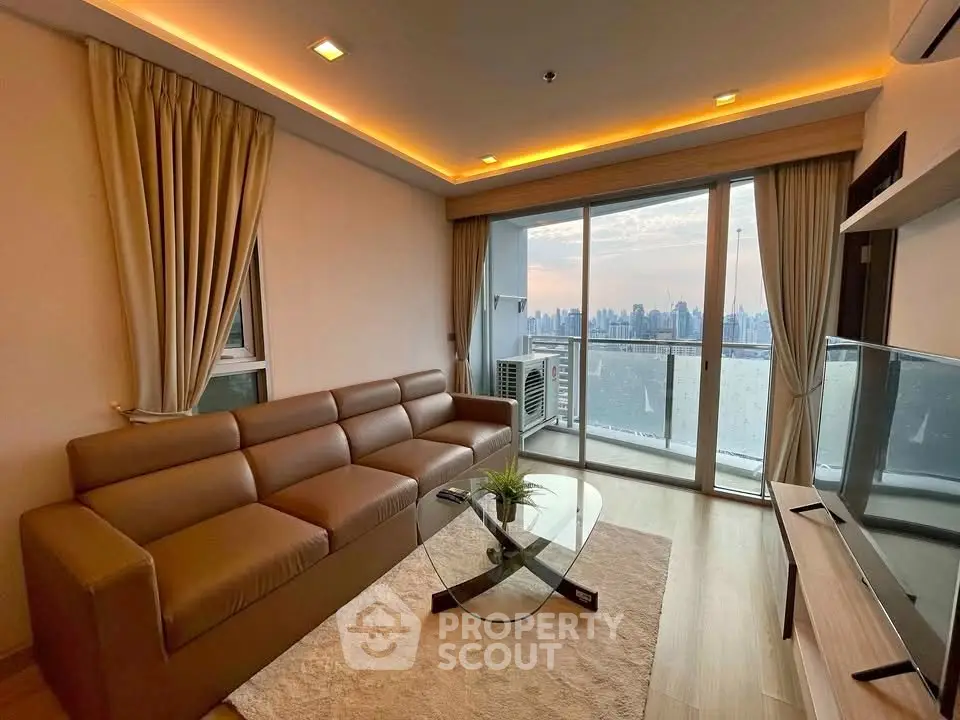 Modern living room with city view, featuring sleek furniture and floor-to-ceiling windows.