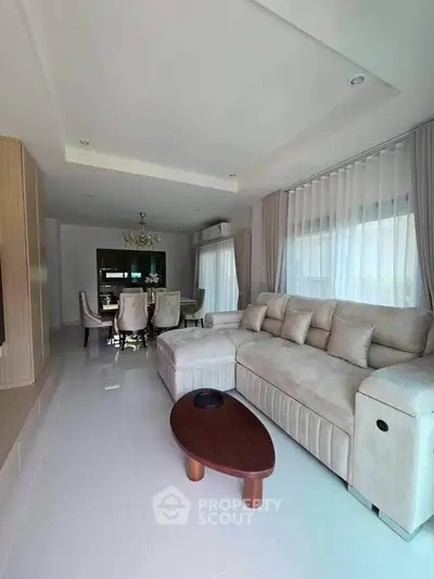 Spacious living room with elegant dining area and plush sofa in modern home