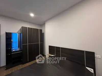 Modern bedroom with sleek dark wood furniture and ambient lighting