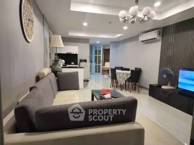 Spacious modern living room with elegant decor and open layout, featuring a cozy dining area and stylish furnishings.