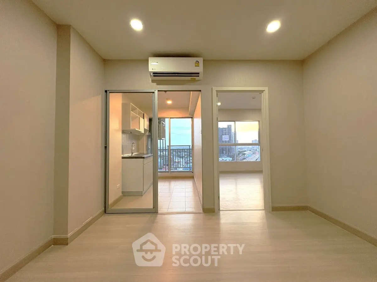 Modern apartment interior with open layout and city view balcony.