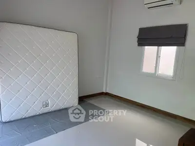 Spacious unfurnished bedroom with air conditioning and natural light.