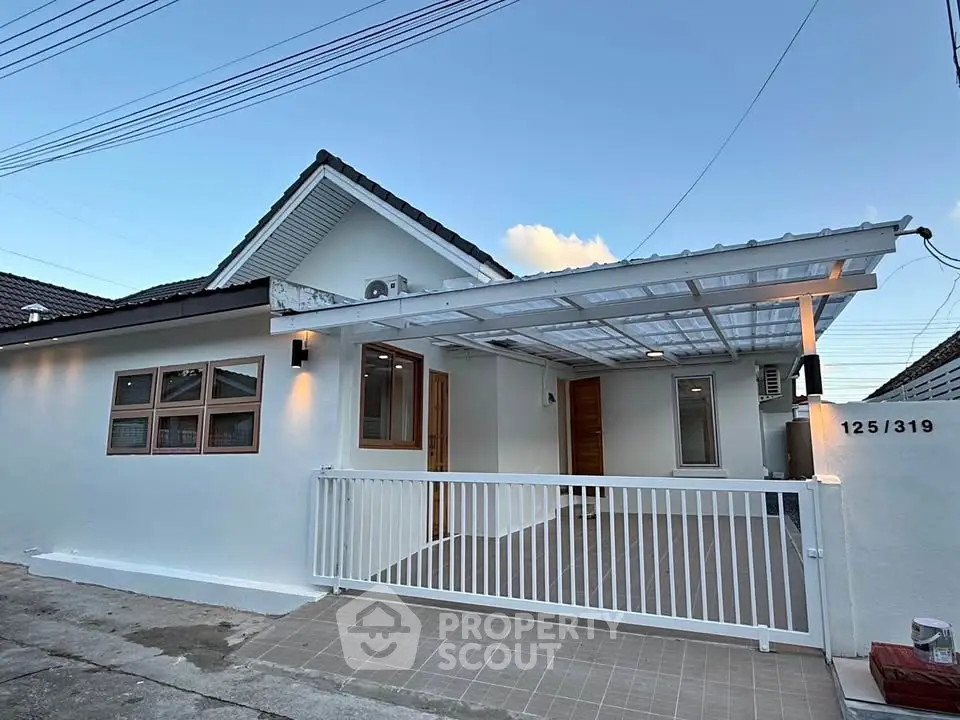 Charming single-story home with modern exterior and covered carport in a serene neighborhood.