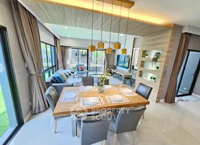Modern open-plan living and dining area with stylish decor and ample natural light.