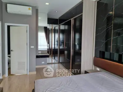 Modern bedroom with sleek design and large mirrored wardrobe