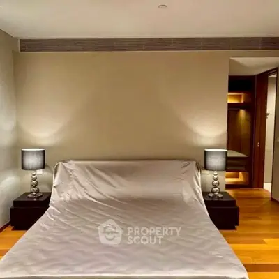 Modern bedroom with elegant lighting and wooden flooring