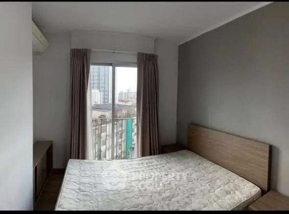Modern bedroom with city view, featuring a large window and minimalist design.