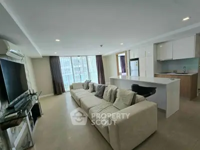 Spacious modern living room with open kitchen and large windows in a luxury apartment.