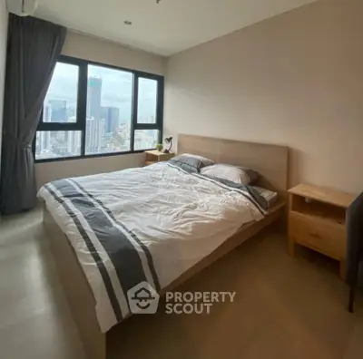 Modern bedroom with city view, featuring a cozy bed and stylish decor.