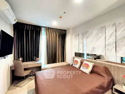 Modern bedroom with stylish decor, featuring a cozy bed, desk, and large window with elegant curtains.