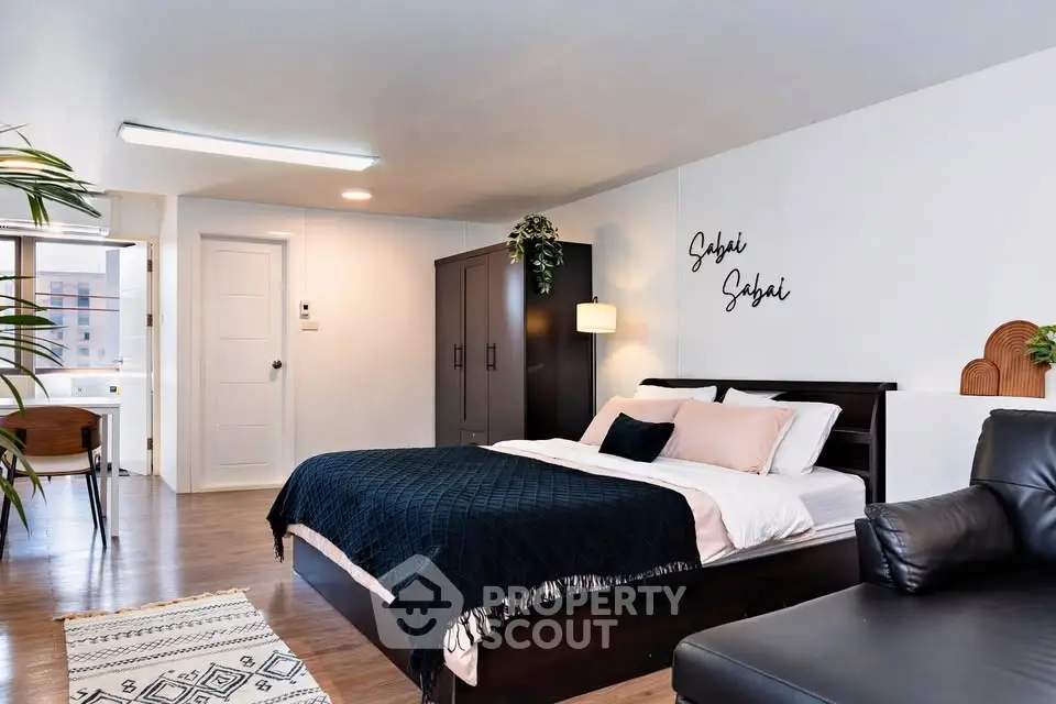Spacious modern bedroom with stylish decor and cozy ambiance in a contemporary apartment.