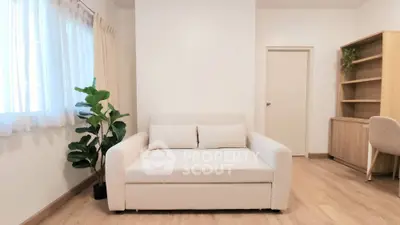 Modern minimalist living room with cozy white sofa and wooden flooring