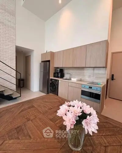 Modern kitchen with wooden cabinets, built-in appliances, and stylish decor in a contemporary home.