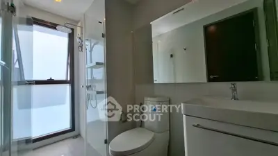Modern bathroom with sleek fixtures and glass shower enclosure