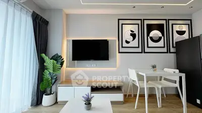 Modern living room with stylish decor, wall art, and natural light, perfect for urban living.