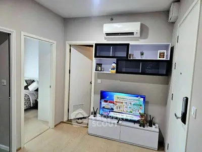 Modern living room with sleek design and entertainment setup in a cozy apartment.