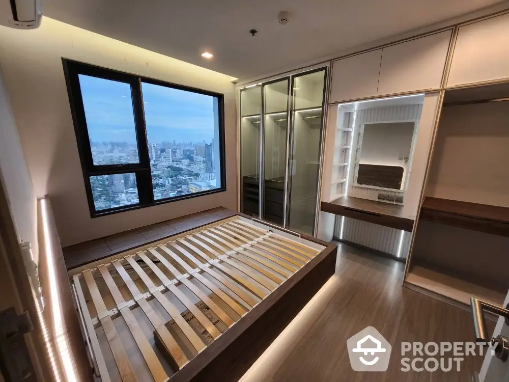 Modern bedroom with city view and built-in wardrobe