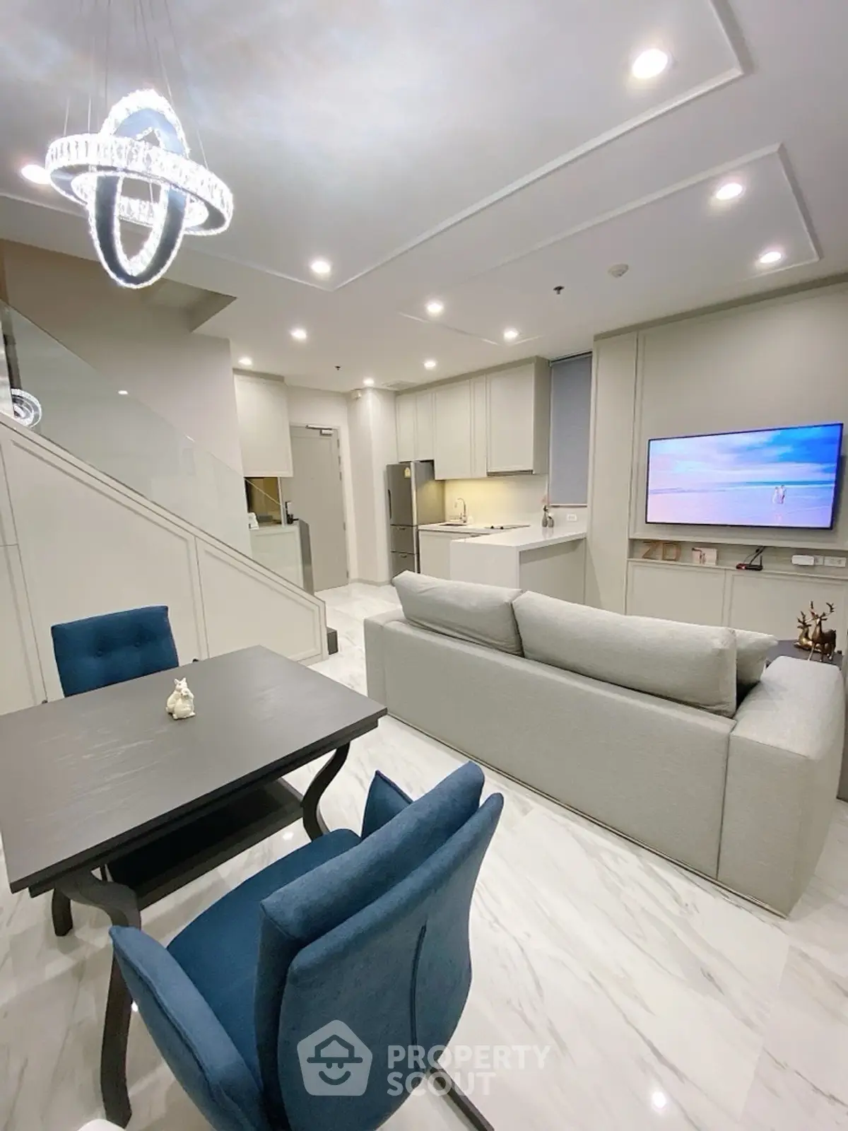 Modern open-plan living room with elegant decor and stylish kitchen