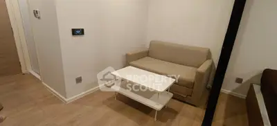 Cozy living room with beige sofa and modern white coffee table, perfect for relaxation.