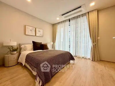 Elegant bedroom with modern decor and large window for natural light