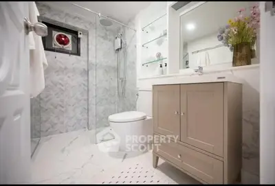 Modern bathroom with elegant vanity and glass shower enclosure