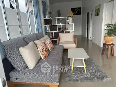 Stylish living room with modern furniture and cozy decor in a bright, airy space.