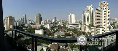 Stunning cityscape view from a high-rise balcony in a vibrant urban area.