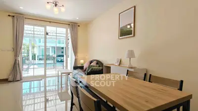 Bright and airy living room with modern furniture and large glass doors opening to a balcony.