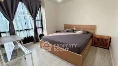 Modern bedroom with large windows and stylish wooden furniture