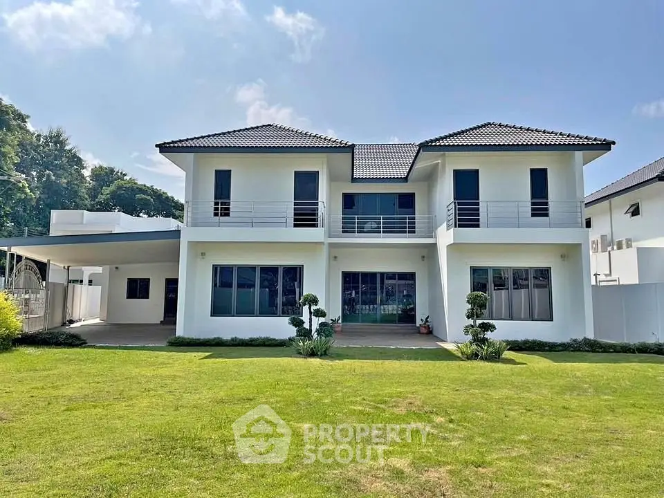 Stunning two-story modern house with spacious lawn and elegant facade.