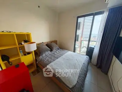 Cozy bedroom with city view, modern furnishings, and ample natural light.