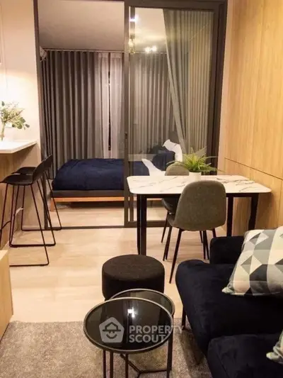 Modern studio apartment with stylish decor and open layout, featuring a cozy living area and elegant dining space.