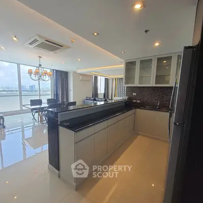 Spacious modern kitchen with open layout and city view, featuring sleek cabinetry and elegant lighting.