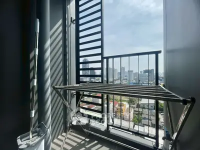 Urban balcony with city view and drying rack, perfect for modern living.