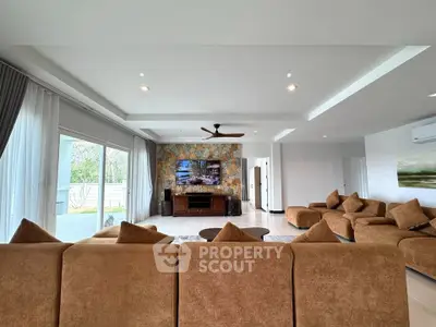Spacious modern living room with large windows and stylish decor