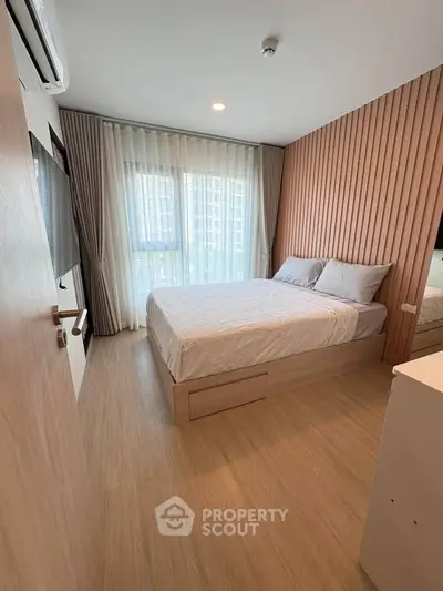 Modern bedroom with wooden accents and large window in stylish apartment