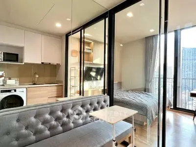 Modern apartment with open layout, featuring a cozy living area, sleek kitchen, and bright bedroom with city views.