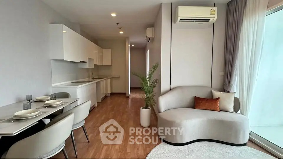 Modern open-plan living room with sleek kitchen and stylish furniture