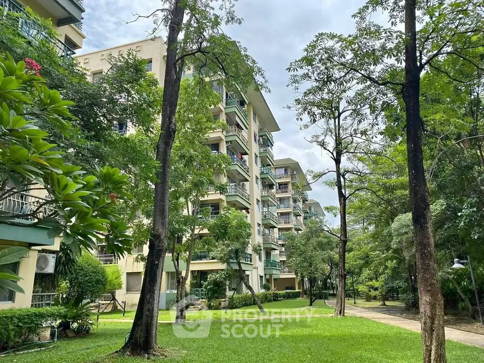 Charming residential building surrounded by lush greenery and serene outdoor space.
