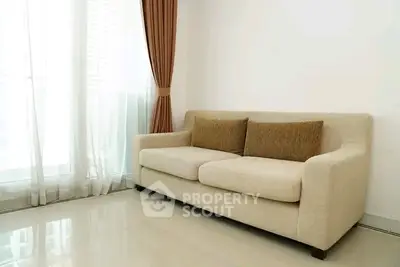 Modern living room with elegant beige sofa and floor-to-ceiling windows