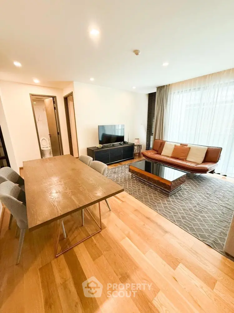 Spacious modern living room with wooden flooring and stylish furniture