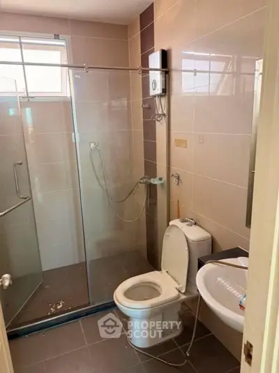 Modern bathroom with glass shower enclosure and sleek fixtures