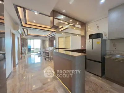 Luxurious open-plan kitchen and living area with modern design and ample natural light.