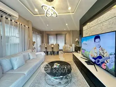Modern living room with stylish decor and large TV, perfect for relaxation and entertainment.