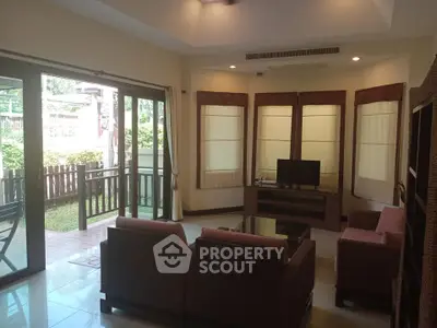 Spacious living room with garden view and elegant furnishings