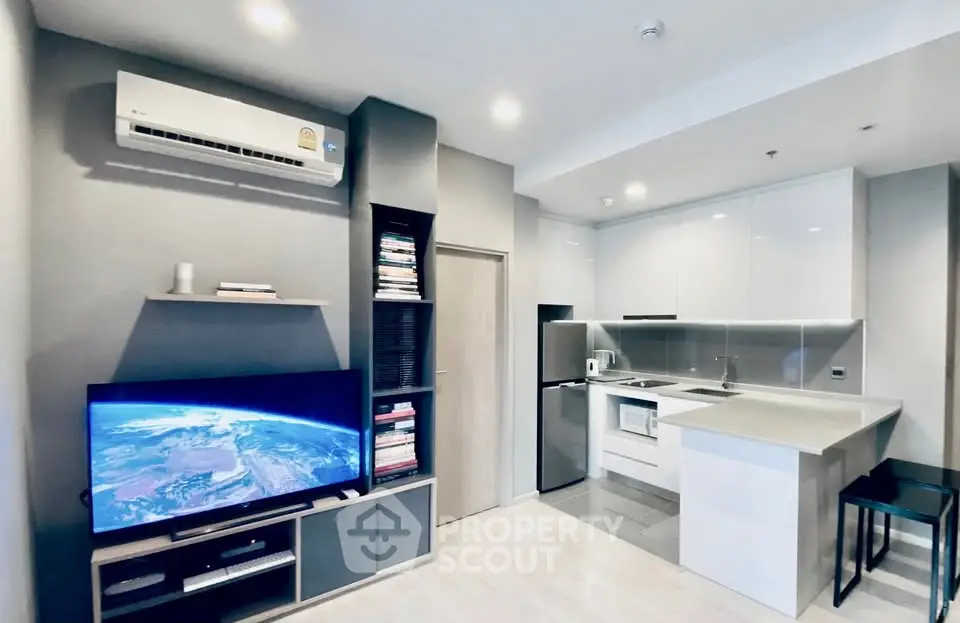 Modern open-plan living room and kitchen with sleek design and appliances.